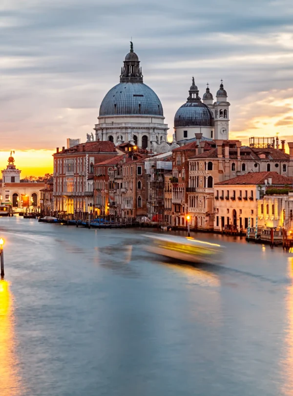 Sunset over Venice’s Grand Canal with the Basilica di Santa Maria della Salute glowing in the evening light — a signature moment on IzzyTrip’s Italy tours.